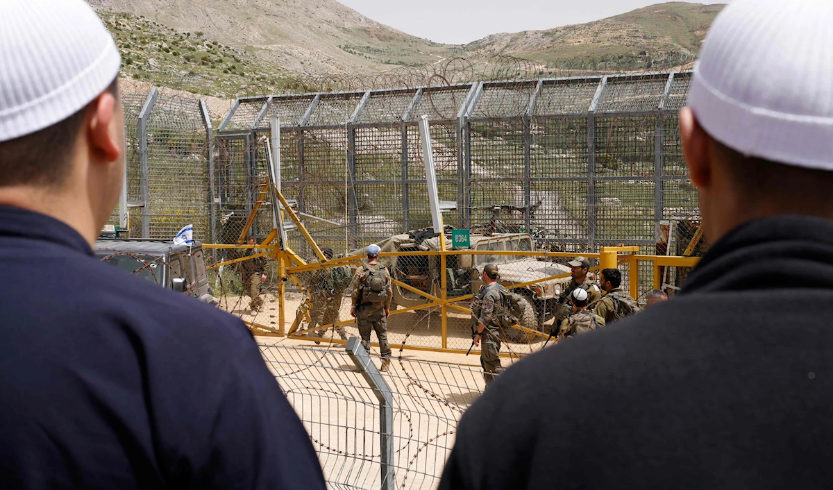 Druze youth and sheikhs gather along the border near Majdal Shams in the occupied Golan Heights amid regional fallout from recent events. (AFP)